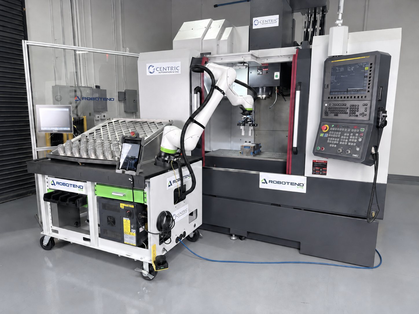 Robotend Lite cell tending a SMEC CNC machining center with a FANUC control, connected by a single blue Ethernet cable, on the Centric Automation shop floor